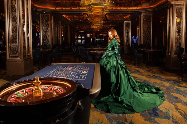 A young woman relaxing with her phone while dynamic casino elements float around her, illustrating the smooth mobile experience offered by the BB444 app.