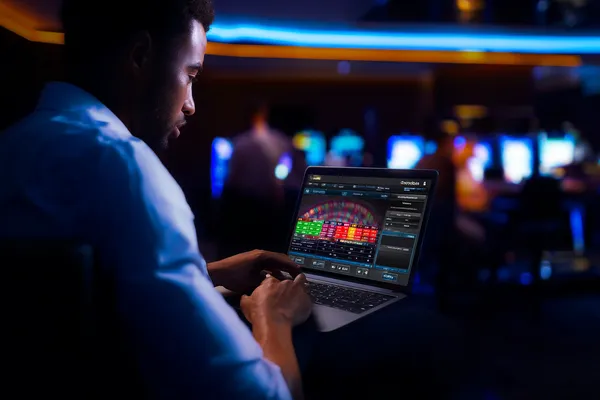 A close-up shot of golden coins falling around a spinning roulette wheel, representing immersive casino action at BB444.