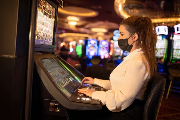 A player using their smartphone during a festive local event, representing BB444’s fully mobile-friendly casino.